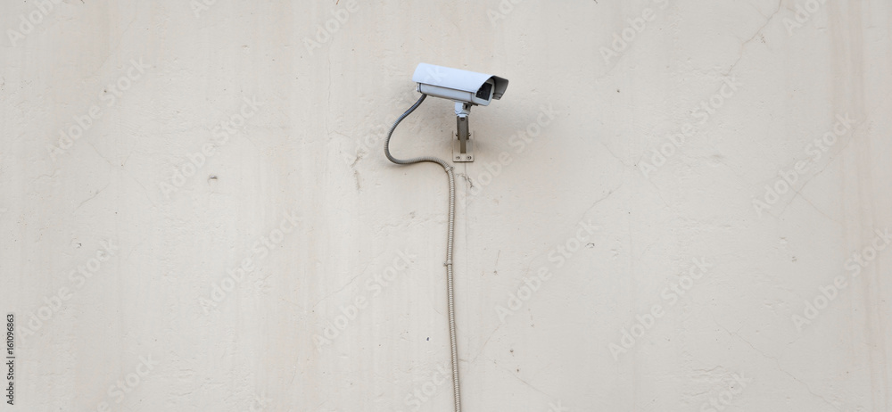 Security camera on plaster wall, security concept