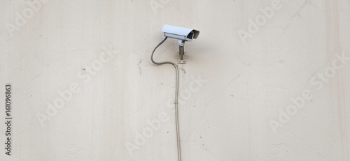 Security camera on plaster wall, security concept