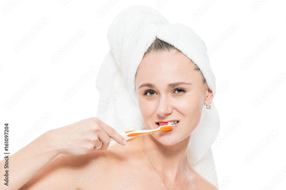 Brushing teeth after taking a bath with a towel on his head, face close-up on a white background Brushing teeth after taking a bath with a towel on his head, face close-up on a white background