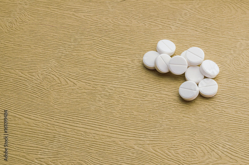 Several white tablets on a wooden table