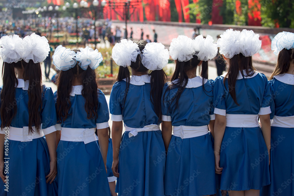 Choir of girls with white bows on head