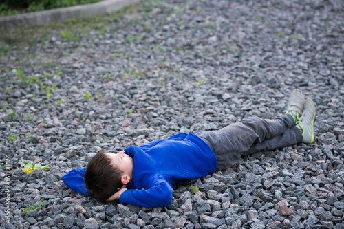 Boy teenager lying on a chalk dreaming