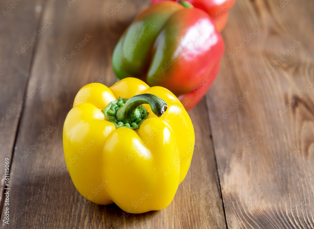 Raw beautiful yellow and red peppers on wooden background Close up Vegetable Healthy and diet food Raw beautiful yellow and red peppers on wooden background Close up Vegetable Healthy and diet food