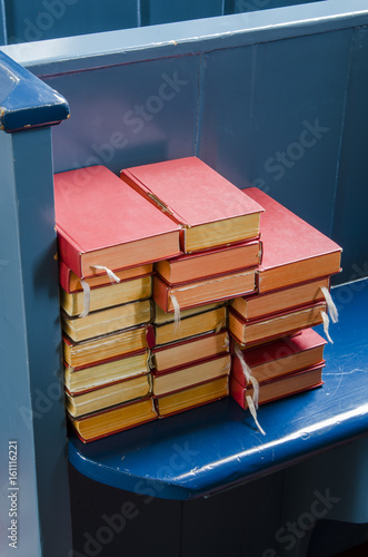 Bibles on a blue pew photo