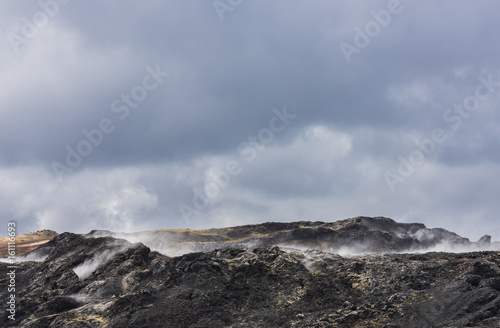 Black Ground and Steam of Geothermal Landscape Krafla, Iceland