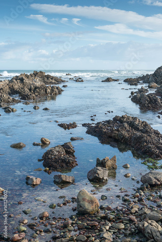 Tranquil tidal pool on a rocky beach in south Africa photo