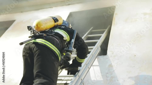 the firefighter climbs the stairs