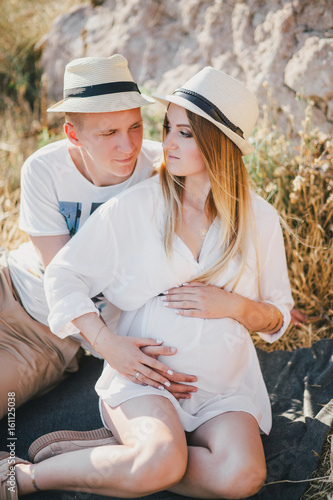 Young beautiful pregnant woman having picnic with her husband © polinaloves