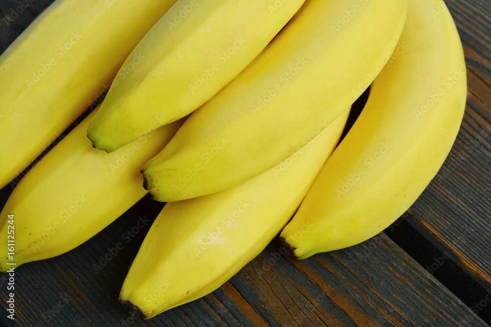 Powerful Reasons to Eat Bananas.
colorful of bananas on wooden background.