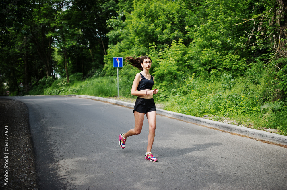 Sport girl at sportswear running in a green park and training at nature. A healthy lifestyle. Sport girl at sportswear running in a green park and training at nature. A healthy lifestyle.