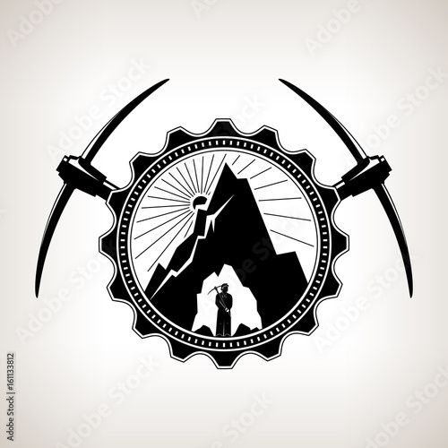 Miner in the Helmet is Holding Pickaxe in the Bowels of the Mountain on a Background of the Sunburst in a Gear with Two Crossed Pickaxes , Vintage Emblem of the Mining Industry, Vector Illustration