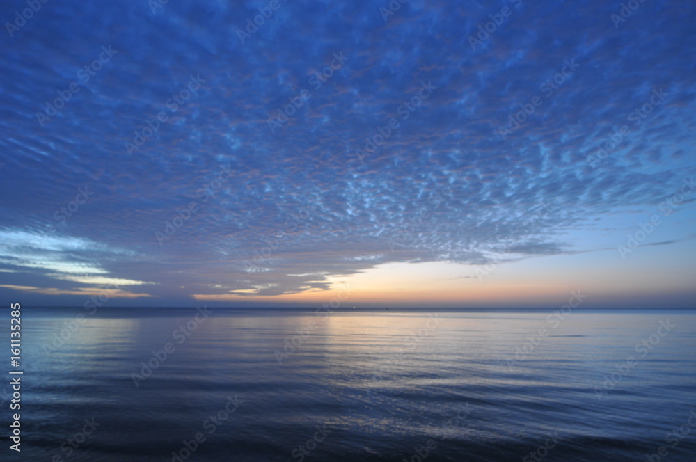Obraz premium beautiful blue sky with clouds background.Sky clouds and sea, Sky with clouds weather nature cloud blue, Sky background on sunset, sunset at sea. variety of colors and hues of the rising sun