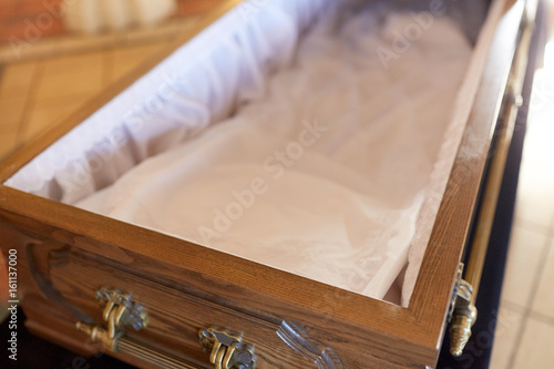 Fotografie close up of open empty coffin in church