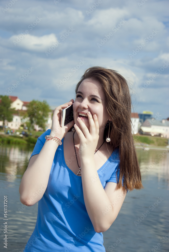 Lovely teen girl with enthusiasm talking on the phone and receiving joyful news and surprise. Lovely teen girl with enthusiasm talking on the phone and receiving joyful news and surprise.