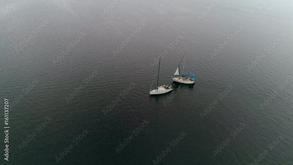 Aerial view of saling yacht tows another yacht Aerial view of saling yacht tows another yacht