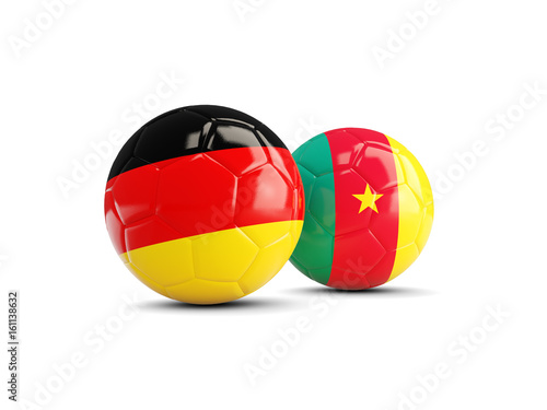 Two footballs with flags of Germany and Cameroon isolated on white