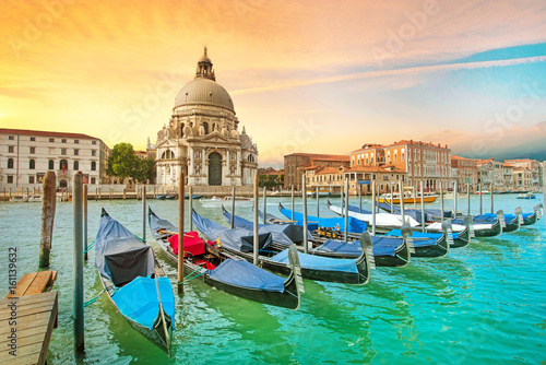 Incredible optimistic color landscape of gondolas on the Grand Canal in the background Basilica Santa Maria della Salutein at dawn in Venice, Italy, Europe. (Romantic travel, honeymoon - concept)