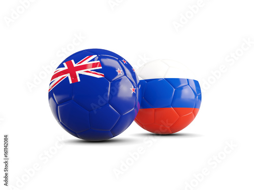 Two footballs with flags of New Zealand and Russia isolated on white