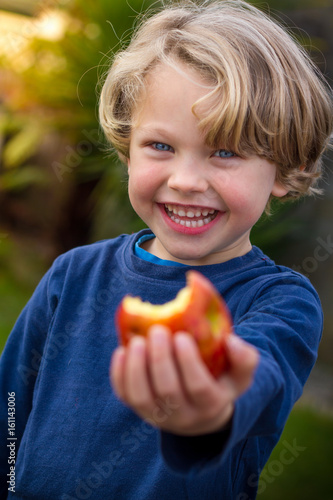 cute 5 year old child eating an apple