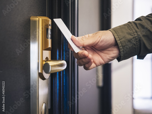 Hand Holding Key card Hotel room access