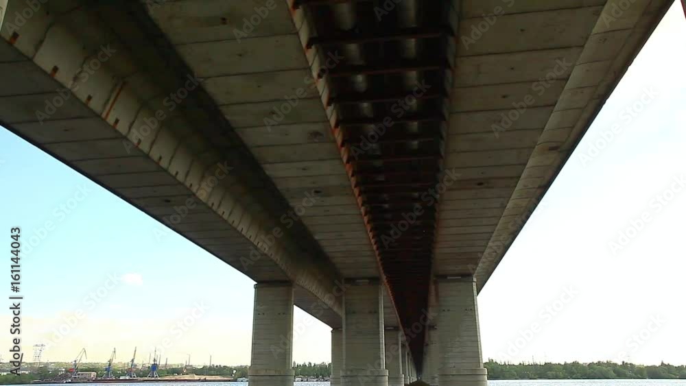 Bridge over the Dnieper river in the summer when the river blooms duckweed Bridge over the Dnieper river in the summer when the river blooms duckweed
