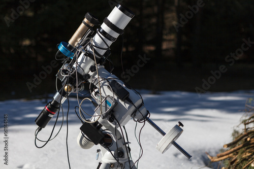 Professional astrophotography telescope equipped with guider scope and astro camera ready for night session