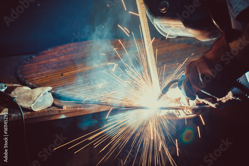 Welding Work. Erecting Technical Steel Industrial Steel Welder In Factory. Craftsman. Soft focus. Shallow DOF.