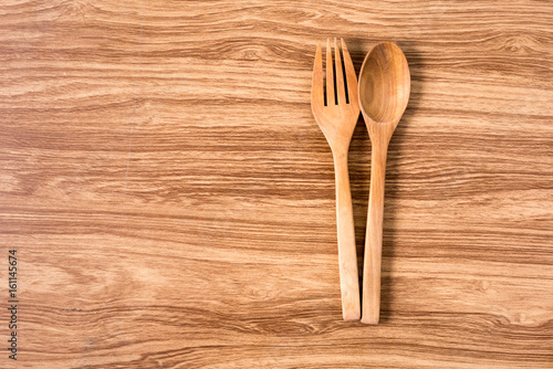 Wooden spoon and fork   with wooden table.