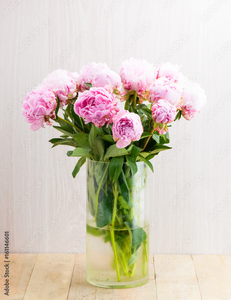 bouquet of pink peonies in glass vase
