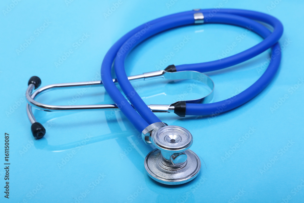 Close up medical stethoscope on blue background Close up medical stethoscope on blue background