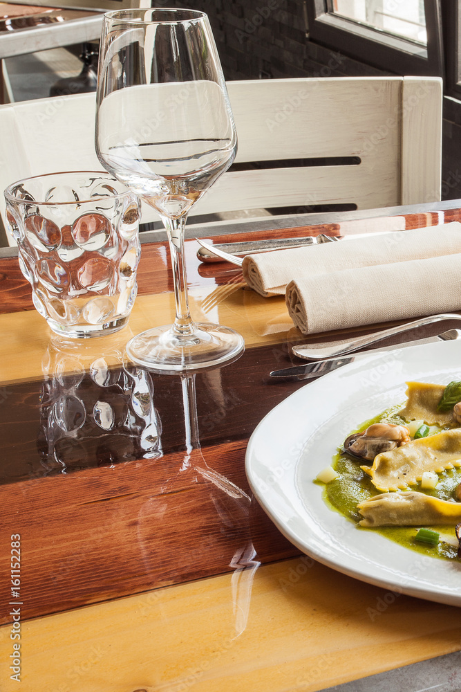 Egg pasta stuffed with mussels and vegetables in the restaurant. Egg pasta stuffed with mussels and vegetables in the restaurant.