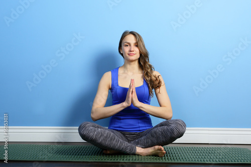 Yoga woman in lotus with praying hands indoor, healthy lifestyle