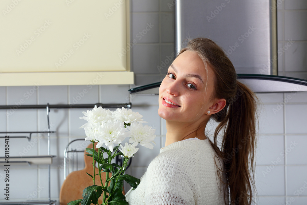 Smiling young woman looking camera, with beautiful flowers Smiling young woman looking camera, with beautiful flowers
