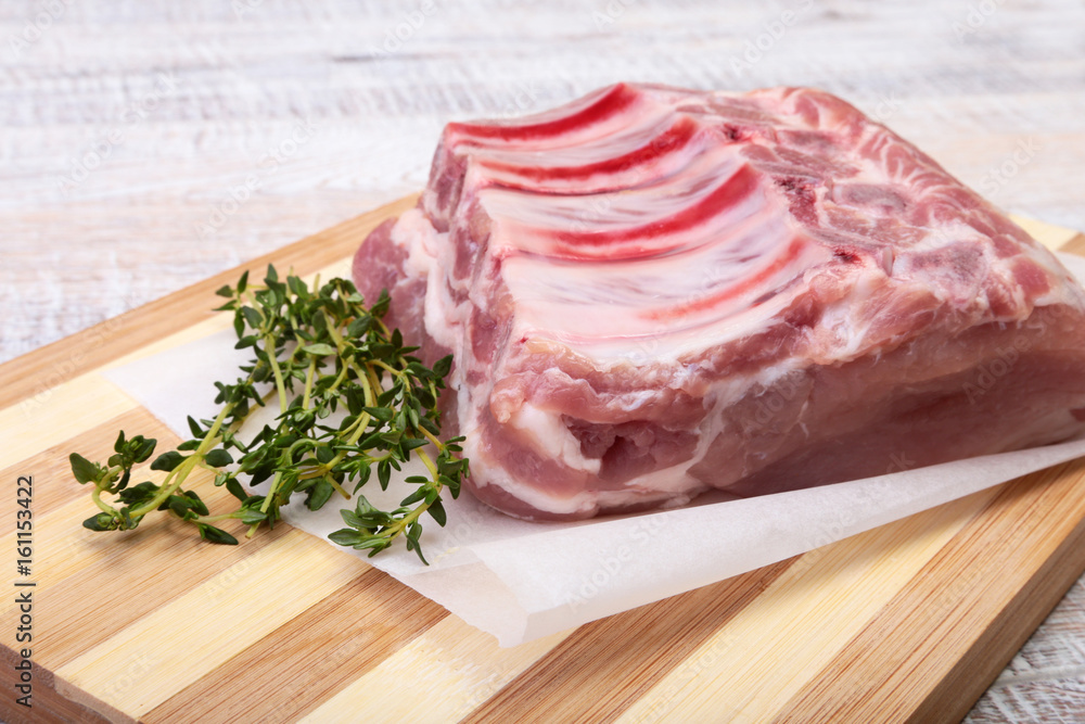 Raw pork chops, spices and rosemary on cutting board. Ready for cooking. Raw pork chops, spices and rosemary on cutting board. Ready for cooking.