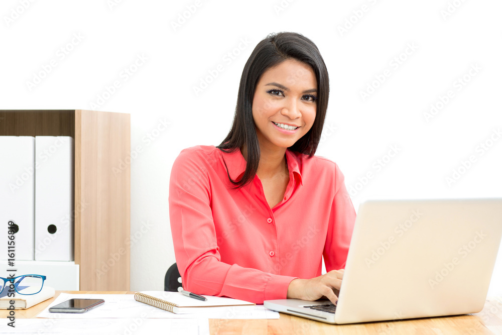 Smiling Asian businesswoman using laptop computer in the office Smiling Asian businesswoman using laptop computer in the office