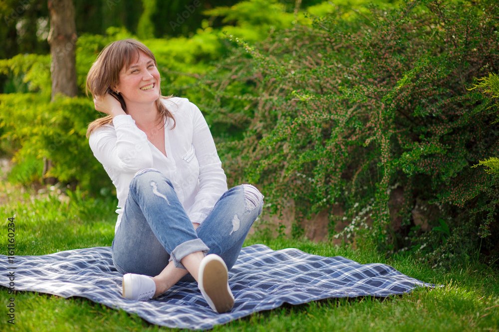 Woman on the grass in the park Woman on the grass in the park