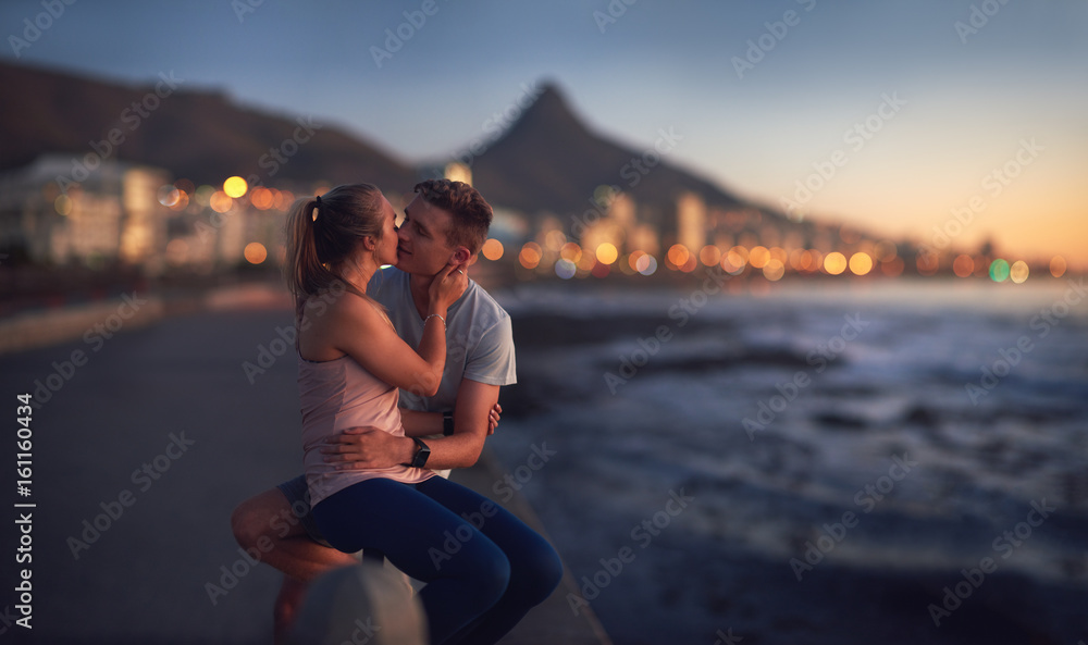 Fototapeta premium Młoda para całuje się w romantyczny moment zachód słońca
