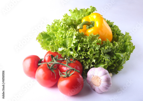 Fresh assorted vegetables bell pepper, tomato, garlic with leaf lettuce. Isolated on white background. Selective focus.