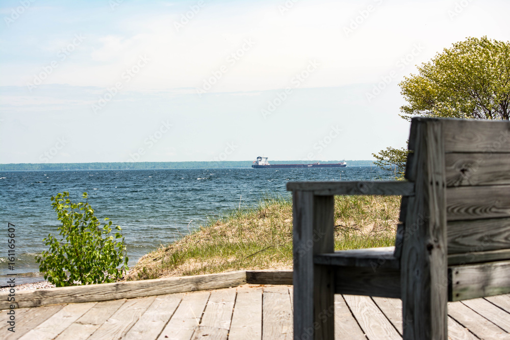bench with Great lakes freighter in background