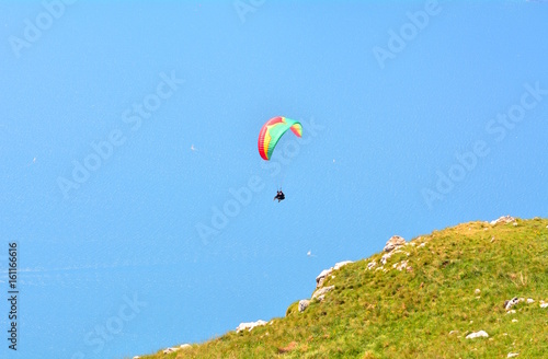 Paragliding on the blue sky on Lake Garda in Italy.