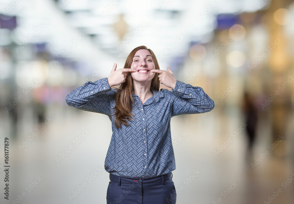 Pretty business woman making a smile gesture over blur background Pretty business woman making a smile gesture over blur background