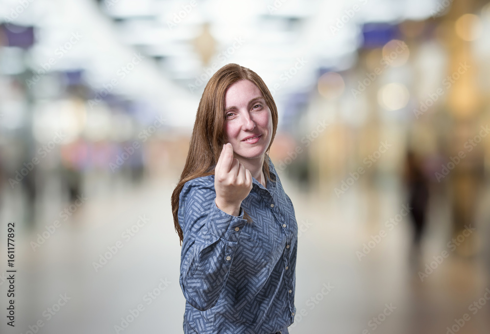 Pretty business woman making expensive gesture over blur background