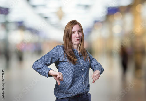Wallpaper Mural Pretty business woman making thumb down gesture over blur background Torontodigital.ca
