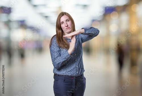 Pretty business woman making time out gesture over blur background