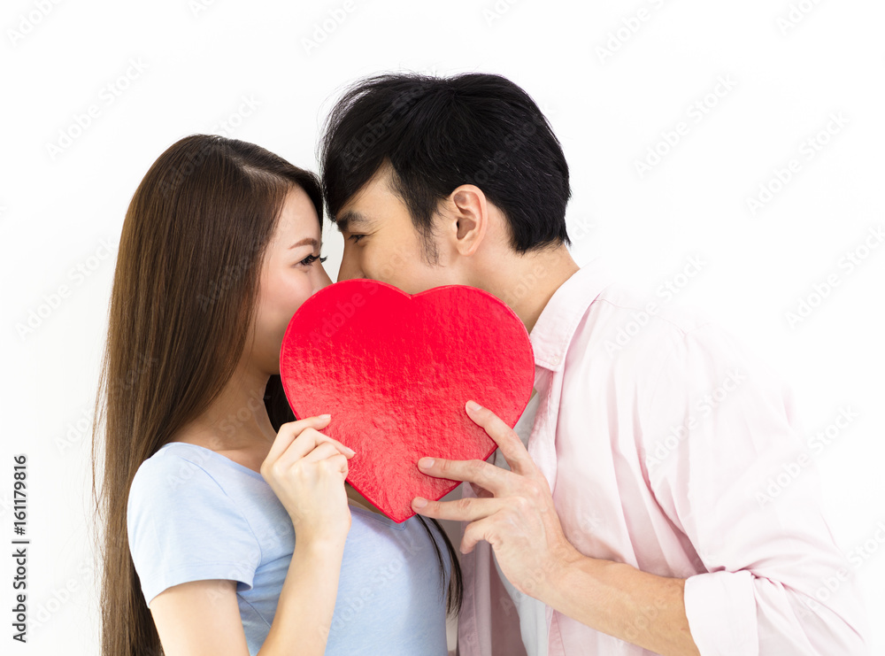 young Couple in love holding red heart. young Couple in love holding red heart.