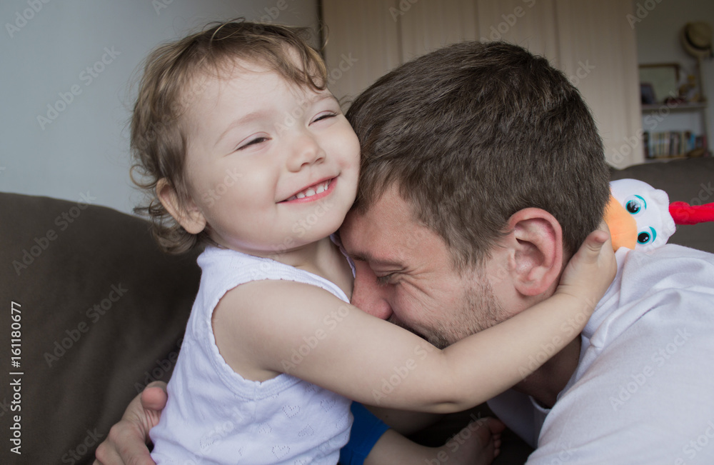The girl hugs the daddy. Dads with a child The girl hugs the daddy. Dads with a child