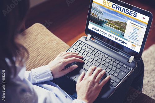 Woman booking cruise travel by internet with a laptop at home.