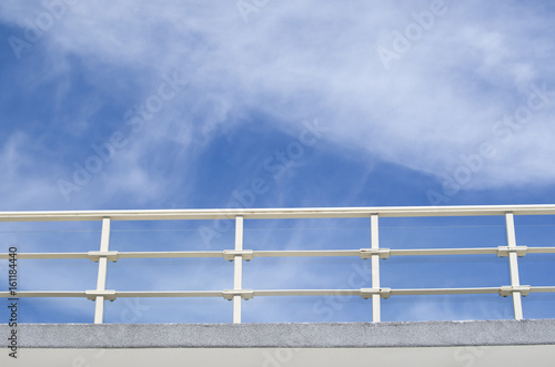 Balcony with white parapet of the cloudy sky