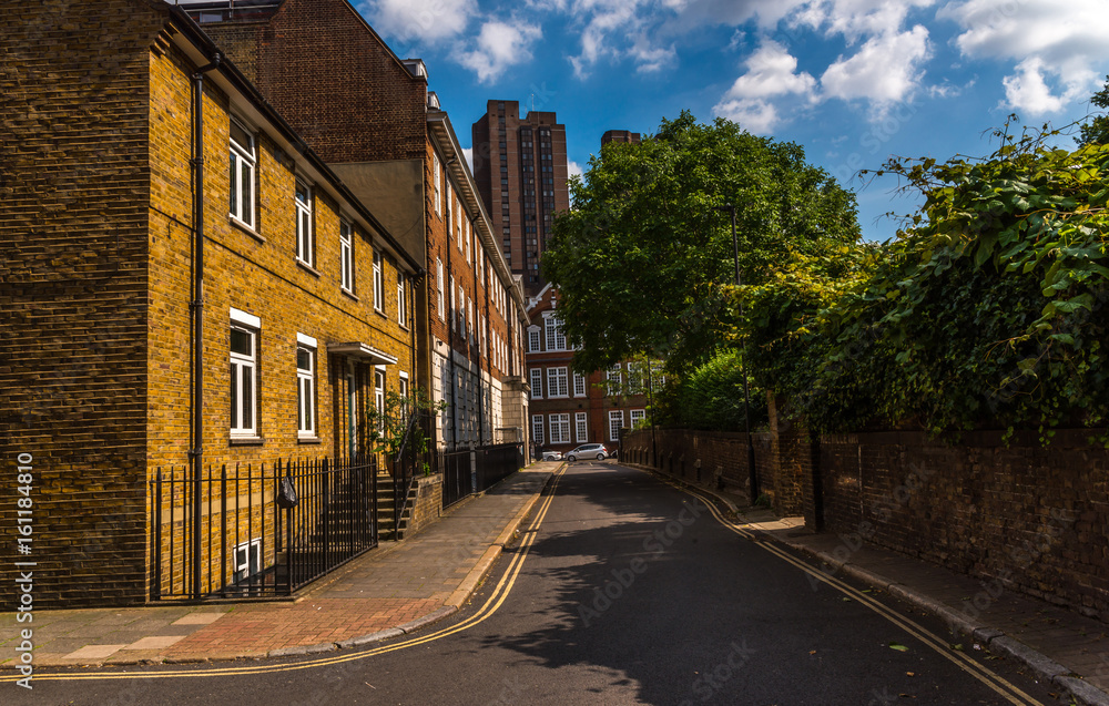 Typical old English buildings, low brick buildings across a narrow street, interesting old London architecture