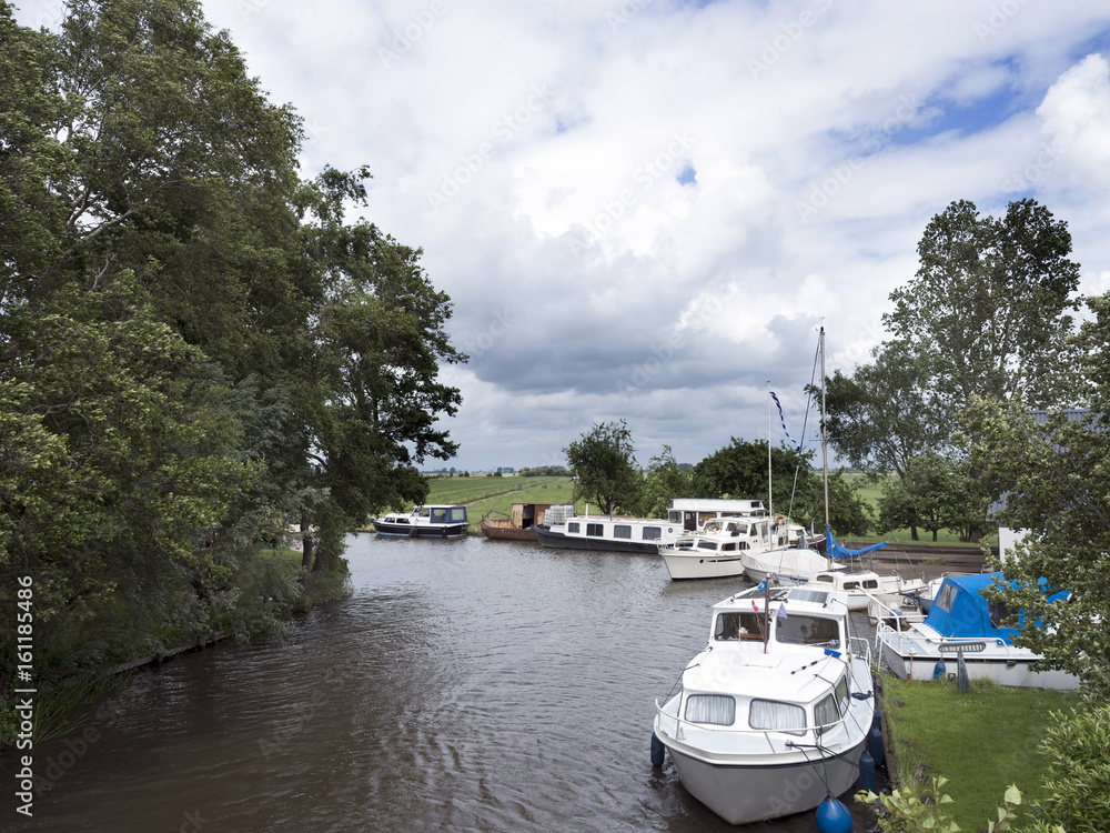boats in canal near Sneek in the dutch province of friesland boats in canal near Sneek in the dutch province of friesland